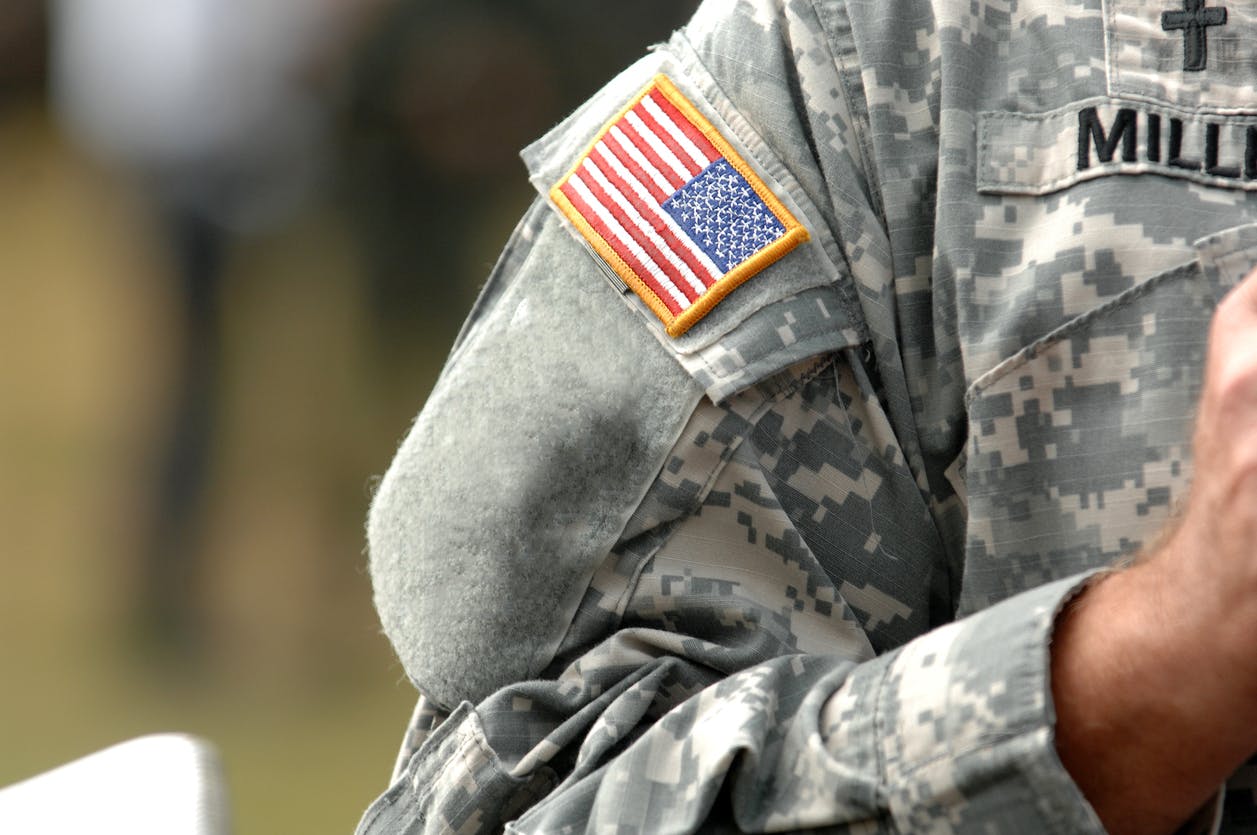 The American Flag Attached To The American Military Uniform.