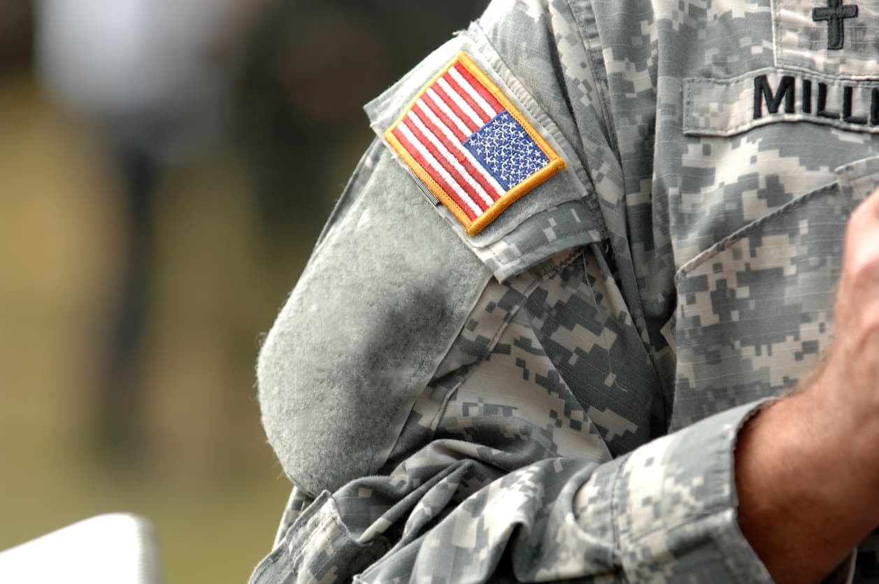 The American Flag Attached To The American Military Uniform.